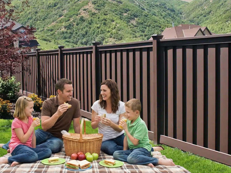 Homeowner with a Trex fence in their backyard